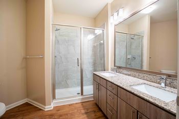A bathroom with a sink and a shower